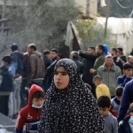 Palestinians, including children, collect usable belongings in the heavily damaged buildings after Israeli attacks in Rafah, Gaza on February 12, 2024. Photo: Yasser Qudih/Anadolu Agency.