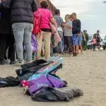 A child's backpack, toys, and other personal belongings that migrants are forced to leave behind as they're processed and transported to a Border Patrol station are heaped on the ground. Photo: John Washington.