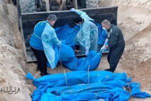 The photo shows people lowering the bodies of deceased Palestinians into a mass grave, wrapped in blue bags. Photo: Eye on Palestine.