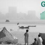 Shacks, boats, and poor children on one side of a river, while skyscrapers are visible on the other side, and a graph showing GDP growth superimposed on the photograph. Photo composition: NewsClick.