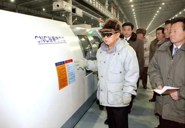 North Korean historic leader Kim Jong Il visiting a factory using CNC technology. File photo.