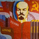 Poster showing Lenin, the Communist symbol, and books with Lenin's name in different languages. Photo: Soviet Artefacts.