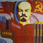 Poster showing Lenin, the Communist symbol, and books with Lenin's name in different languages. Photo: Soviet Artefacts.