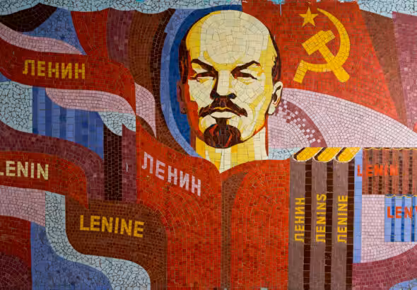 Poster showing Lenin, the Communist symbol, and books with Lenin's name in different languages. Photo: Soviet Artefacts.