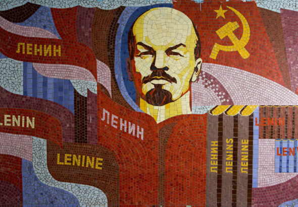 Poster showing Lenin, the Communist symbol, and books with Lenin's name in different languages. Photo: Soviet Artefacts.