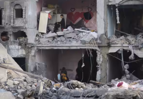 Palestinians amid the wreckage of a house in Rafah destroyed by Israeli bombardment, February 14, 2024. Photo: AP.