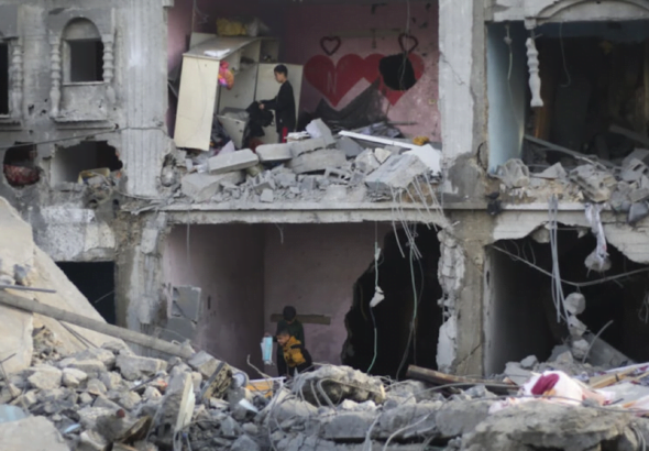 Palestinians amid the wreckage of a house in Rafah destroyed by Israeli bombardment, February 14, 2024. Photo: AP.