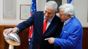 Israeli Prime Minister Benjamin Netanyahu holds the NFL Super Bowl trophy during a meeting with New England Patriots owner Robert Kraft in Jerusalem, June 20, 2019. Photo: Sebastian Scheiner/AP.