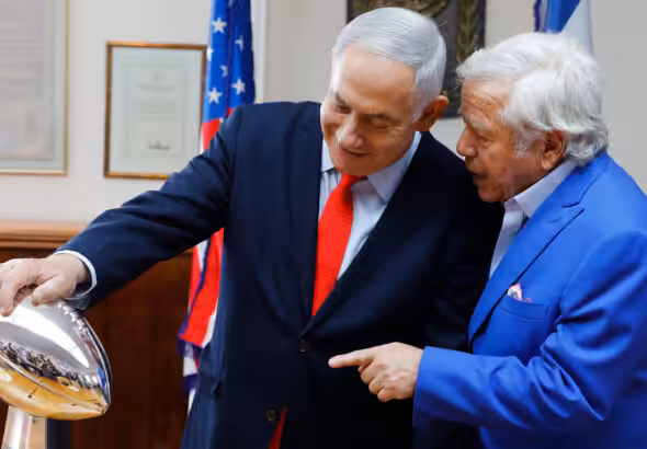 Israeli Prime Minister Benjamin Netanyahu holds the NFL Super Bowl trophy during a meeting with New England Patriots owner Robert Kraft in Jerusalem, June 20, 2019. Photo: Sebastian Scheiner/AP.