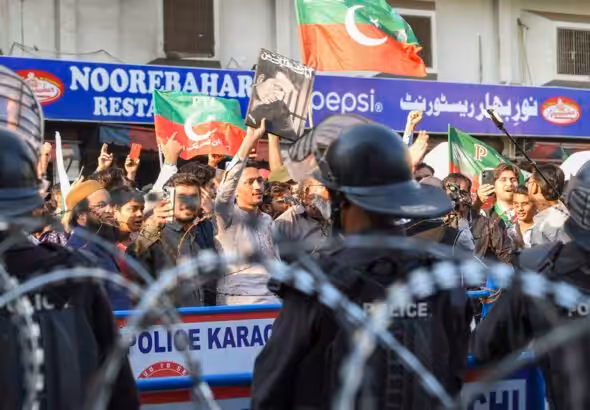 Supporters of former Prime Minister Imran Khan’s Pakistan Tehreek-e-Insaf (PTI) protest against the alleged skewing in Pakistan's national election results, in Karachi on February 11, 2024. Photo by AFP.