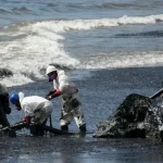 Workers of Heritage Petroleum Oil and Gas Company clean up the oil spill that reached Rockly Bay beach, in Scarborough, southwestern Tobago, Trinidad and Tobago, February 11, 2024. Photo: AP/Akash Boodan.