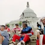 Native Americans sitting on the steps of the US Capitol. Photo: AP/Denis Paquin.