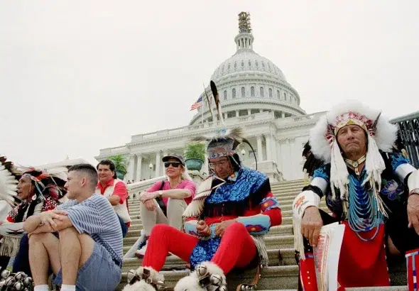 Native Americans sitting on the steps of the US Capitol. Photo: AP/Denis Paquin.