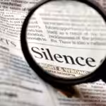 Photo composition showing a newspaper with a magnifying glass where "Silence. right & wrong" can be read. Photo: Pixabay/CC0 1.0.