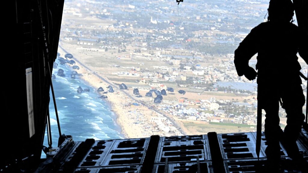 A US Air Force loadmaster releases humanitarian aid pallets over Gaza on March 2, 2024. Photo:  Christopher Hubenthal/US Air Force via Reuters.