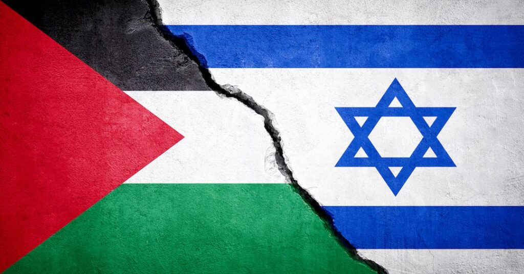 Photo composition showing the left side of a Palestinian flag (left) and the right side of an Israeli flag (right) divided by a wall crack. Photo: Stock image.