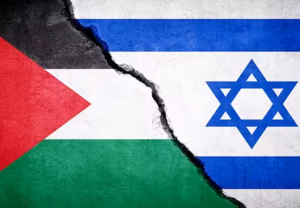 Photo composition showing the left side of a Palestinian flag (left) and the right side of an Israeli flag (right) divided by a wall crack. Photo: Stock image.