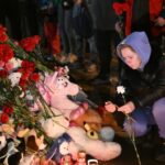 A woman lights a candle at a makeshift memorial near the Crocus City Hall in memory of the victims of a terrorist attack on the concert venue near Moscow on March 22, Russia. Photo: Maksim Blinov/Sputnik.