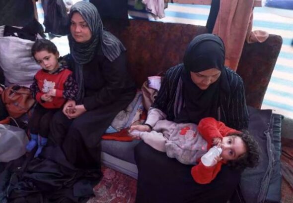 Displaced Palestinian women take care of their children inside a tent in Rafah in the southern Gaza Strip on 7 March 2024, on the eve of International Women's Day, amid Israel's ongoing genocidal war on the besieged strip. Photo: AFP.