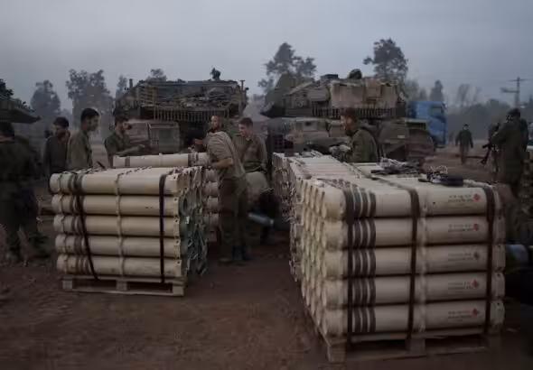 Israeli soldiers from the artillery unit store tank shells in a staging area in the Gaza envelope in southern occupied Palestine. January 1, 2024. Photo: AP.