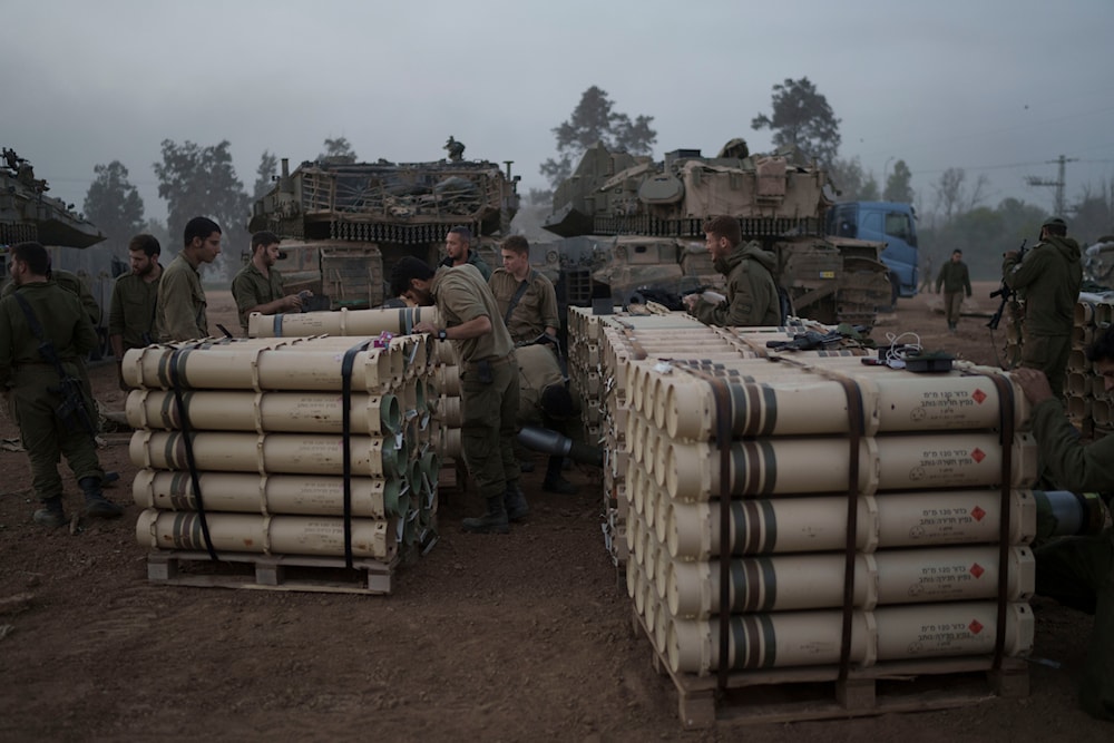 Israeli soldiers from the artillery unit store tank shells in a staging area in the Gaza envelope in southern occupied Palestine. January 1, 2024. Photo: AP.