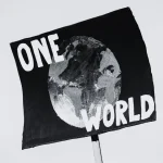 Banner with a painted globe and a caption that reads "one world." Photo: Markus Spiske/Pexels.