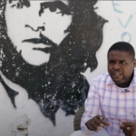 G9 leader Jimmy Cherizier speaks with a Che Guevara mural in the background during an interview for the documentary film "Another Vision: Inside Haiti's Uprising," produced by Haiti Liberté and Uncaptured Media (2022).