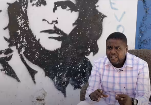 G9 leader Jimmy Cherizier speaks with a Che Guevara mural in the background during an interview for the documentary film "Another Vision: Inside Haiti's Uprising," produced by Haiti Liberté and Uncaptured Media (2022).
