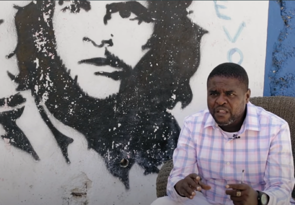 G9 leader Jimmy Cherizier speaks with a Che Guevara mural in the background during an interview for the documentary film "Another Vision: Inside Haiti's Uprising," produced by Haiti Liberté and Uncaptured Media (2022).