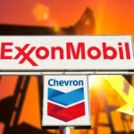 Hoardings showing the names and logos of ExxonMobil and Chevron in the backdrop of a silhouette of oil extraction machinery. Photo: El CEO.