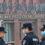 Security personnel stand guard outside the Wuhan Institute of Virology in China, February 3, 2021. Photo: Hector Retamal/AFP/Getty Images.