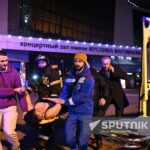 A woman injured in the Moscow terror attack being transported to an ambulance by emergency services. Photo: Sputnik/Sergey Bobylev.