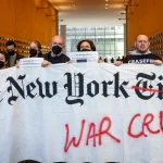 Pro-Palestine protesters hold a banner inside the lobby of The New York Times's offices during an action criticizing the newspaper's coverage of Israel's war on Gaza, March 14, 2024, New York City, USA. Photo: Michael Nigro/Sipa USA/Reuters.
