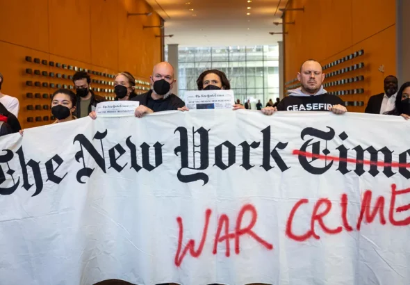 Pro-Palestine protesters hold a banner inside the lobby of The New York Times's offices during an action criticizing the newspaper's coverage of Israel's war on Gaza, March 14, 2024, New York City, USA. Photo: Michael Nigro/Sipa USA/Reuters.
