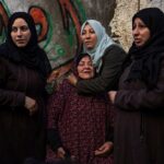 Palestinian women react after their home was hit by an Israeli airstrike in Rafah, southern Gaza Strip, February 8, 2024. Photo: AP.