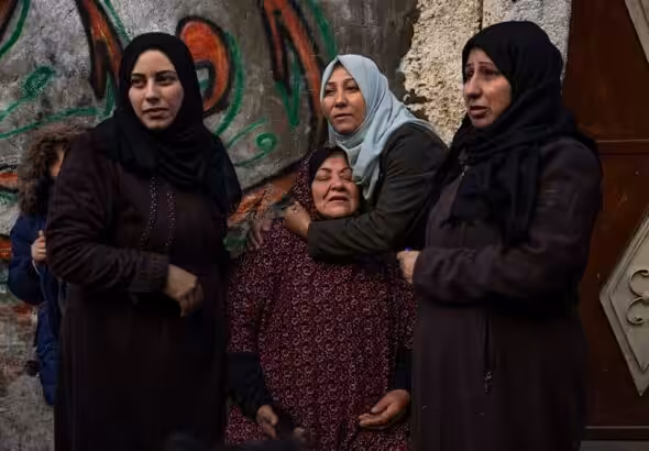 Palestinian women react after their home was hit by an Israeli airstrike in Rafah, southern Gaza Strip, February 8, 2024. Photo: AP.