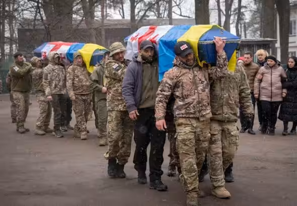 Georgian Legion mercenaries carry coffins of Ukrainian soldiers who died in a battle against Russian troops, during a funeral ceremony in Kiev, March 12, 2024. Photo: AP.