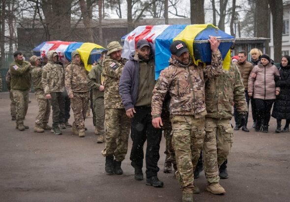 Georgian Legion mercenaries carry coffins of Ukrainian soldiers who died in a battle against Russian troops, during a funeral ceremony in Kiev, March 12, 2024. Photo: AP.