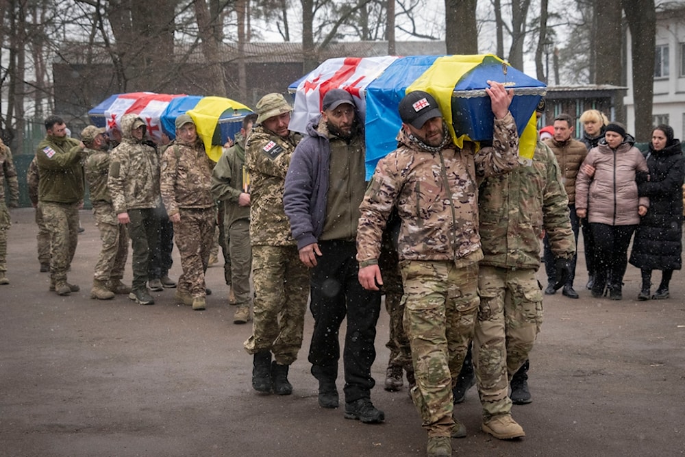 Georgian Legion mercenaries carry coffins of Ukrainian soldiers who died in a battle against Russian troops, during a funeral ceremony in Kiev, March 12, 2024. Photo: AP.