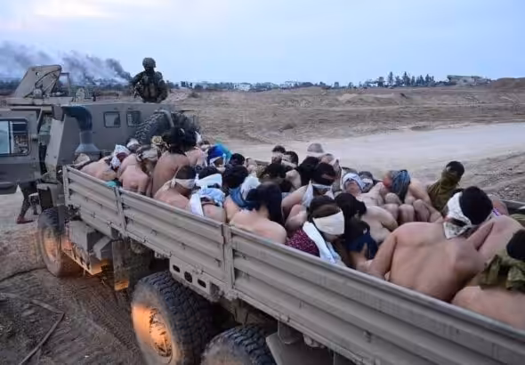 Half naked Gazans taken hostage in the back of a truck by IOF "soldiers." Photo: X.