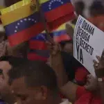 People waving Venezuelan flags alongside a banner reading: "Obama repeal the Executive Order now!" Photo: File photo.