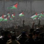 Palestinian demonstrators wave Palestine’s flags during a rally marking Land Day in Beit Hanoun, in the northern Gaza Strip, Palestine, March 30, 2012. Photo: AP.
