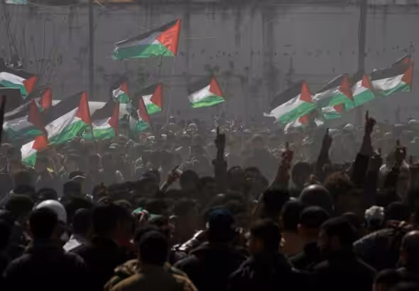 Palestinian demonstrators wave Palestine’s flags during a rally marking Land Day in Beit Hanoun, in the northern Gaza Strip, Palestine, March 30, 2012. Photo: AP.