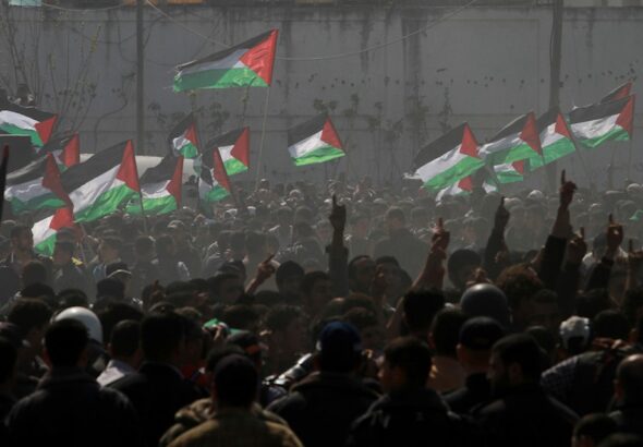 Palestinian demonstrators wave Palestine’s flags during a rally marking Land Day in Beit Hanoun, in the northern Gaza Strip, Palestine, March 30, 2012. Photo: AP.
