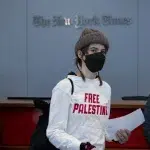 Pro-Palestine protesters flood the lobby of the New York Times offices and block the security entrances during a demonstration against the newspaper’s coverage of Israel's war on Gaza on March 14, 2024, in New York City. Photo: Michael Nigro/Sipa via AP Images.
