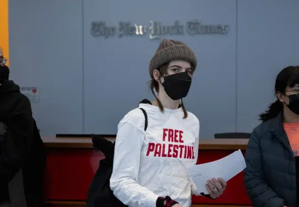 Pro-Palestine protesters flood the lobby of the New York Times offices and block the security entrances during a demonstration against the newspaper’s coverage of Israel's war on Gaza on March 14, 2024, in New York City. Photo: Michael Nigro/Sipa via AP Images.