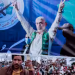 A Yemeni man holds a poster of Yahya Sinwar, head of Hamas, during a protest marking Quds Day in support of Palestinians in Gaza, Sanaa, Yemen, April 05, 2024. Photo: Osamah Abdulrahman/AP.