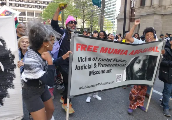 People marching through the streets of Philadelphia with posters demanding freedom for Mumia Abu-Jamal on April 24, 2024. Photos: Stephen Millies/SLL.