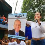 Venezuelan far-right politician María Corina Machado campaigning in the Venezuelan countryside, holding a poster with the photo of Edmundo Gonzalez Urrutia. Photo: X/@alcaldeledezma.