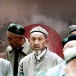 Elderly Uyghur men with images of bombed buildings in the background. Photo compilation: Al-Mayadeen.